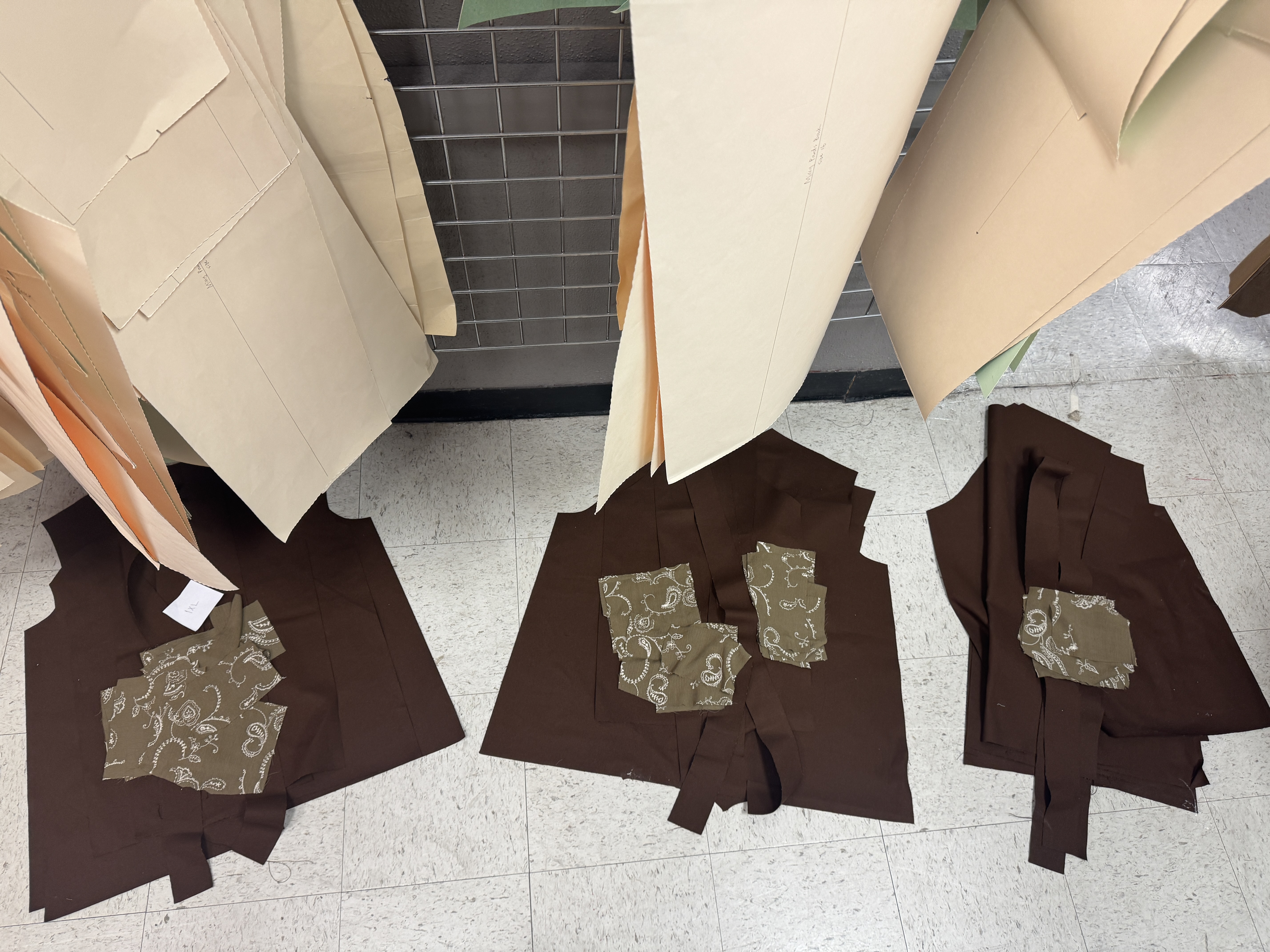 Cut pattern pieces and fabric laid out on floor
