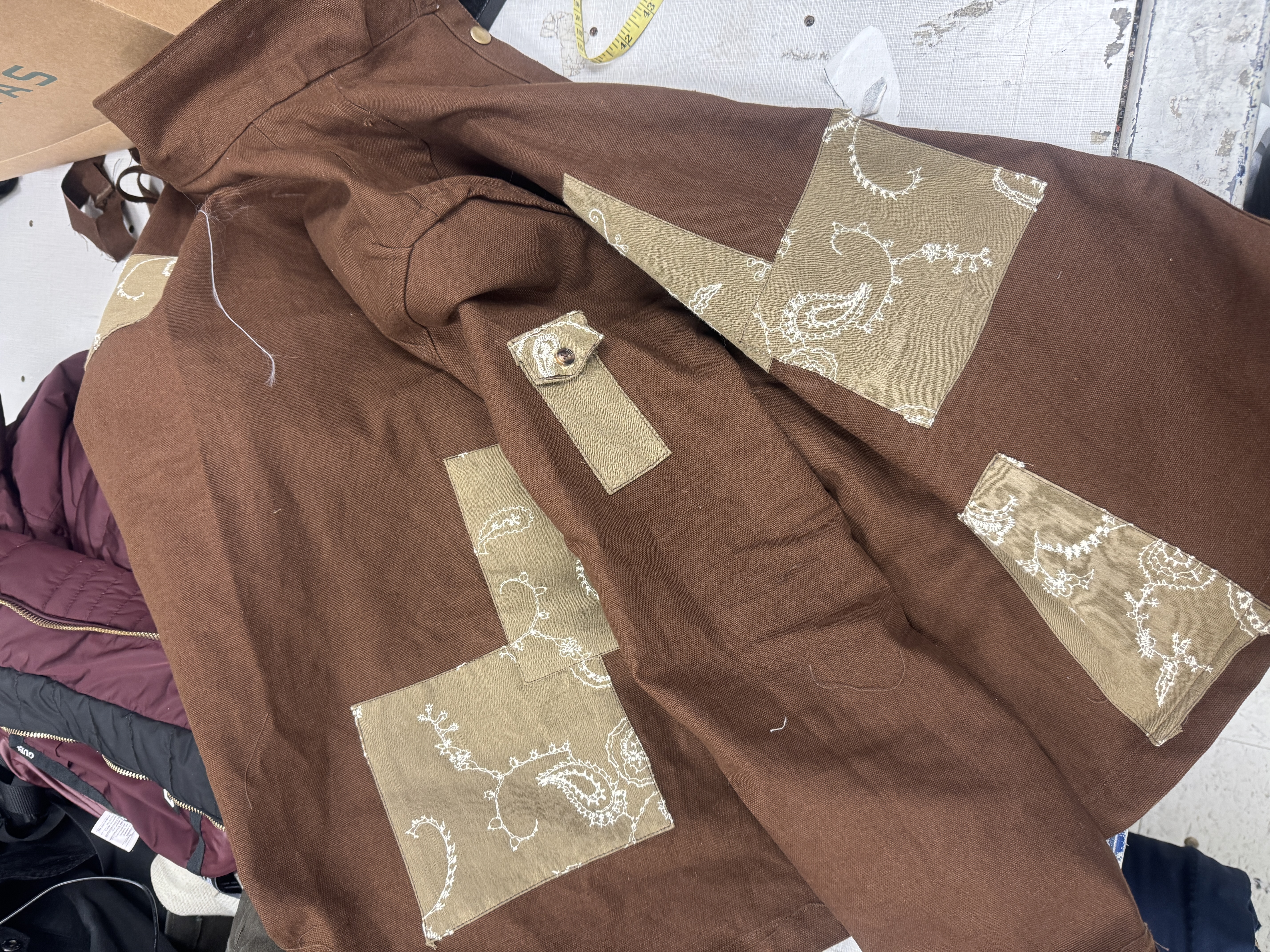 Finished jacket flat with patchwork detail
